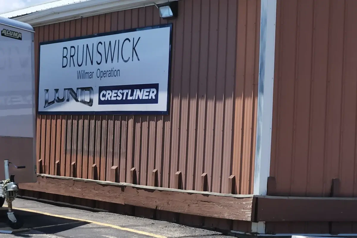 A brown building hosts the sign "Brunswick" on it