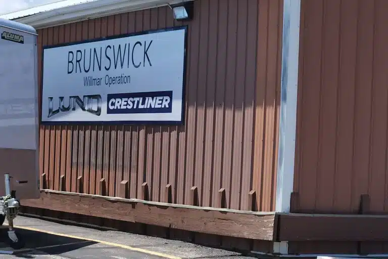 A brown building hosts the sign "Brunswick" on it