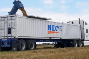 A Nexyst semi truck gets loaded in field