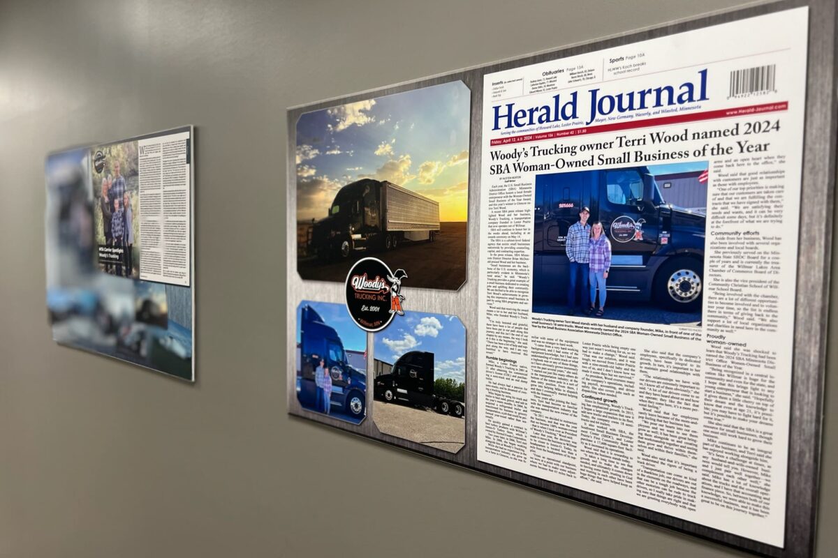 Woody's Trucking articles framed on wall