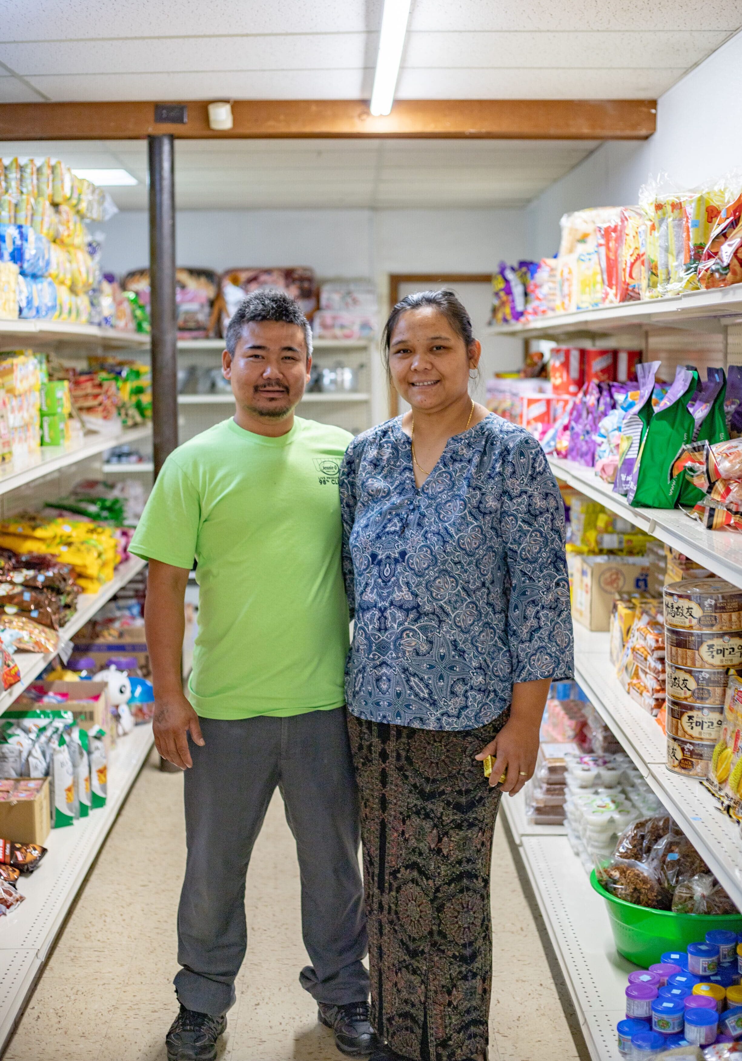 chaws market family owners standing in grocery isle