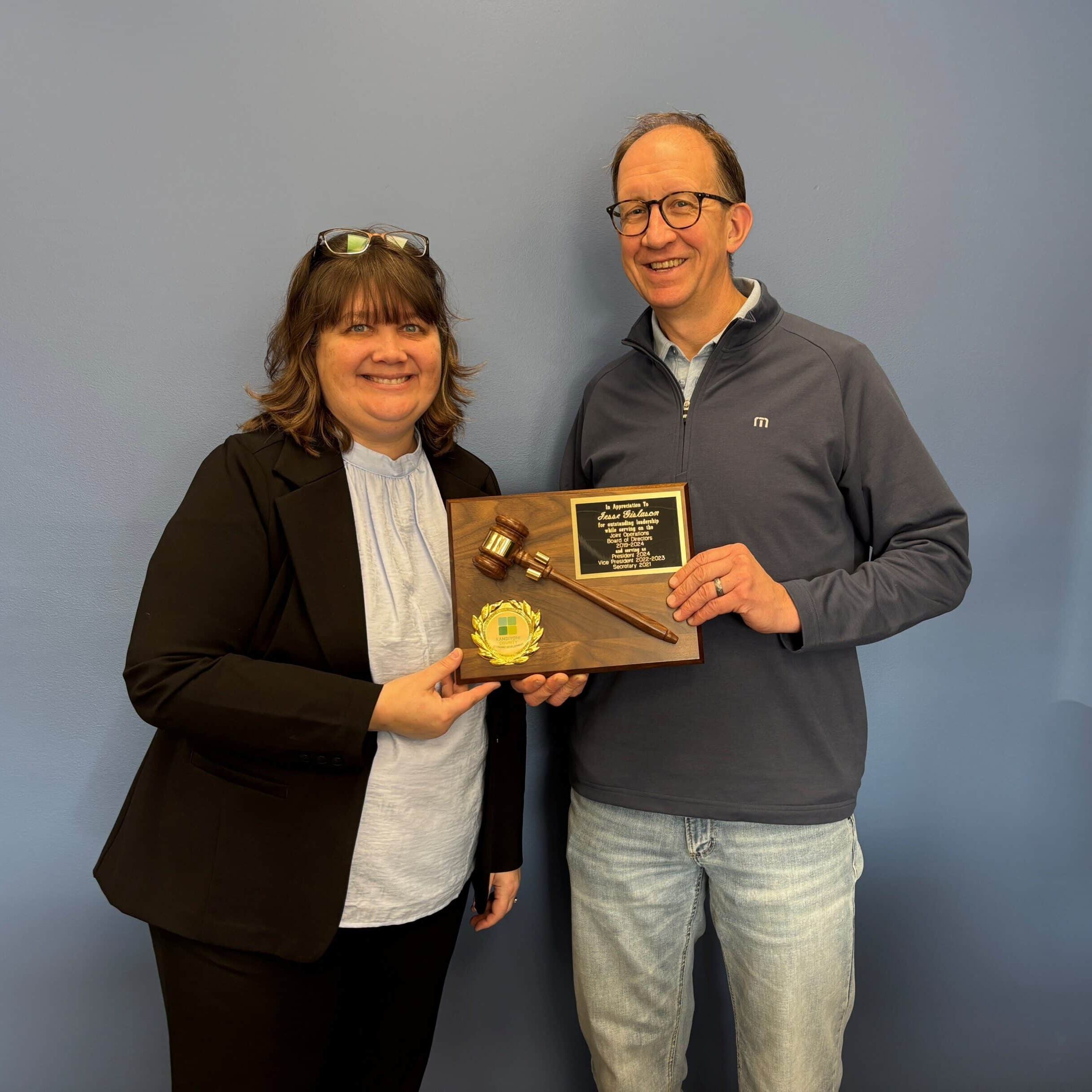 Jesse Gislason - past Chair of KCED Joint Operations Board receiving a plaque from Michelle Marotzke, KCED Interim Executive Director and Business Development Manager