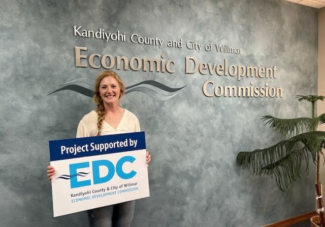 woman holding project support by sign